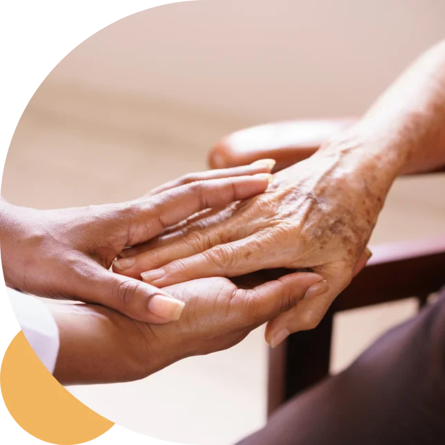 Two hands, one younger and one older, gently hold each other, symbolizing care or support.